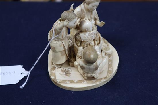 A good Japanese ivory okimono of a lady and children playing, Meiji period, H.9.5cm, W.12.2cm